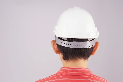 Engineer wear red shirt and white engineer hat turn back on white background.
