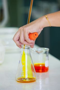 researcher working in a biotechnology lab / biochemical engineer working with microplate in a laboratory experiment