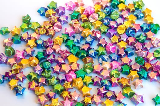 mass of colorful star paper on white background