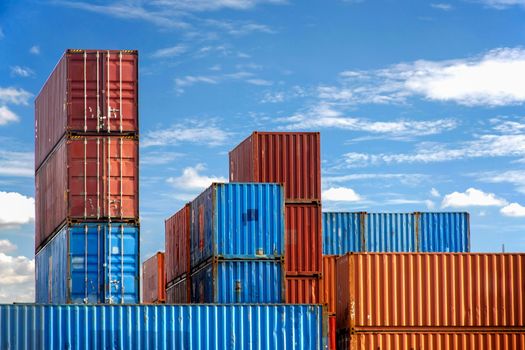 Stack of Cargo Containers in an intermodal yard with blue sky