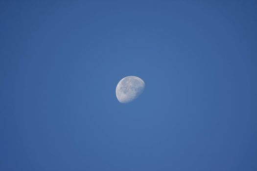 beautiful half moon on blue sky in morning day