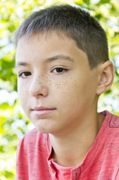 Portrait of cute freckles boy with dark brown eyes