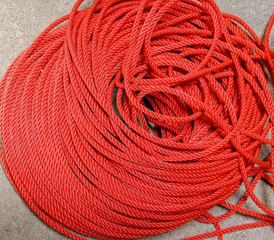 roll texture of red nylon rope on cement floor