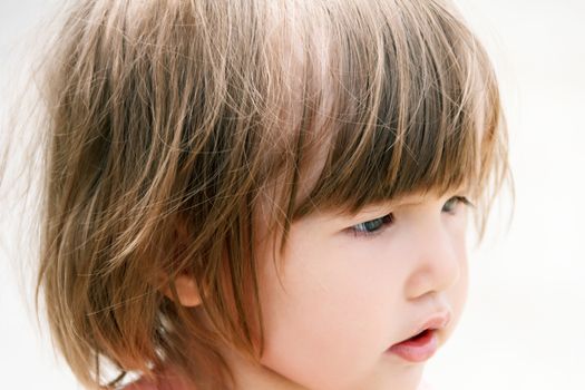 Portrait of cute Caucasian girl with short hair in profile