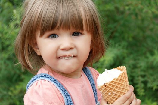 Horizontal photo of cute girl are eating icecream in summer time