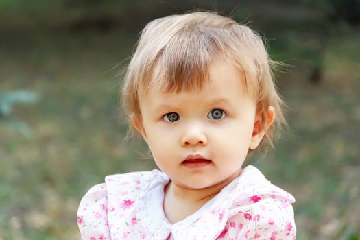 Cute Caucasian girl with short hair in summer