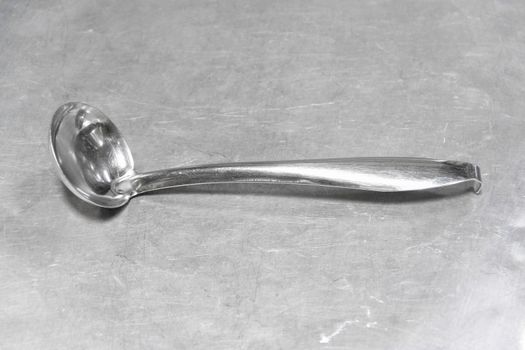 bright stainless ladle on aluminium stainless floor