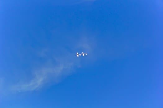 Photo of two flying military airplanes in blue sky