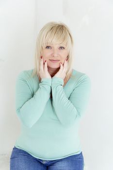 European blond woman with blue eyes in green