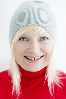 Blond woman with blue eyes in grey hat