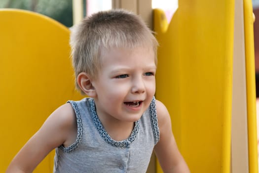 Portrait of cute blond boy with open mouth
