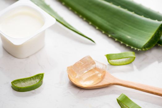 Aloe vera yogurt with fresh leaves on a wooden table