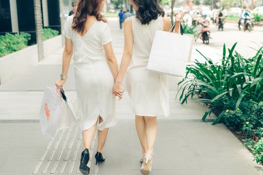 Beautiful asian girls with shopping bags walking on street at the mall