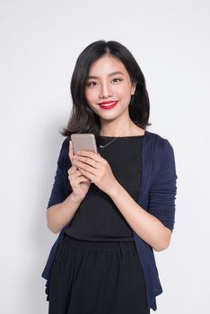 Young asian woman using smartphone isolated on white.