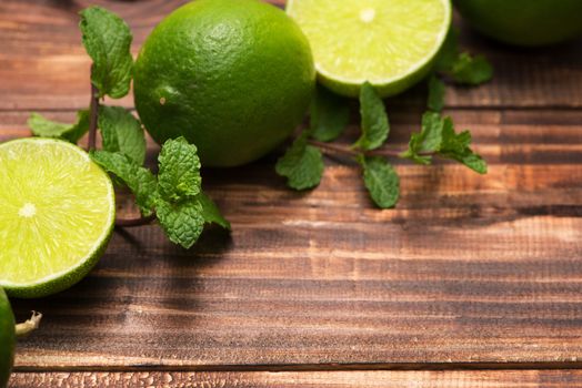 Fresh limes on wooden  table, Top view, background.