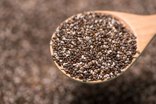 Close-up of ealthy chia seeds in a spoon. Text space.