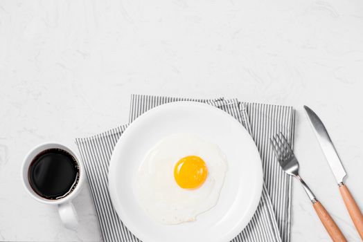 Top view of traditional healthy easy quick breakfast meal made of fried eggs served on a plate.