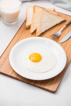 Top view of traditional healthy easy quick breakfast meal made of fried eggs served on a plate.