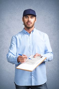 Handsome young delivery man holding document folder ask to sign invoice