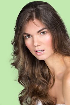 Studio portrait of a pretty woman with wavy fair hair and natural make-up