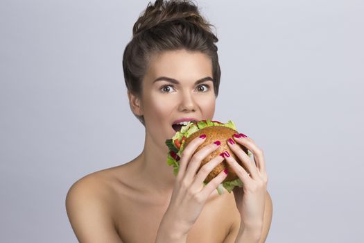 Young woman eating hamburger made of vegetables, healthy eating concept