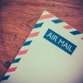 Retro Photo Of An Old Air Mail Envelope Of A Rustic Wooden Background