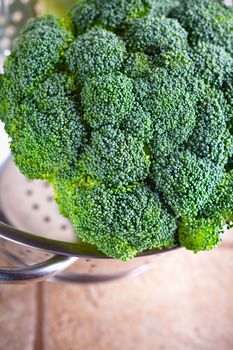 A bunch of fresh green Broccoli in colander