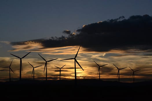 Wind turbine silhouettes at twilight