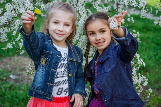 Two happy girls enjoying spring garden