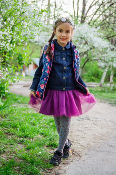 Pretty girl in wreath enjoying spring garden