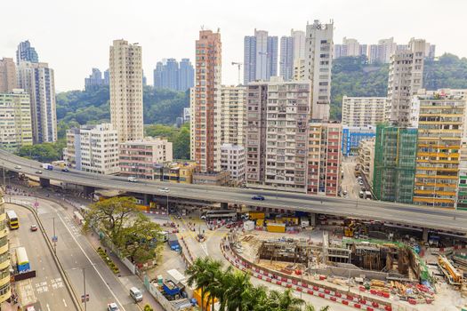 Old houses surrounded modern skyscrapers in Hong Kong. Hong Kong is popular tourist destination of Asia and leading financial centre of the world.