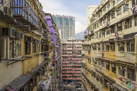 Old houses surrounded modern skyscrapers in Hong Kong. Hong Kong is popular tourist destination of Asia and leading financial centre of the world.