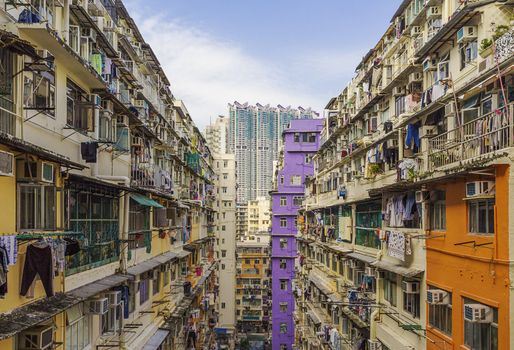 Old houses surrounded modern skyscrapers in Hong Kong. Hong Kong is popular tourist destination of Asia and leading financial centre of the world.