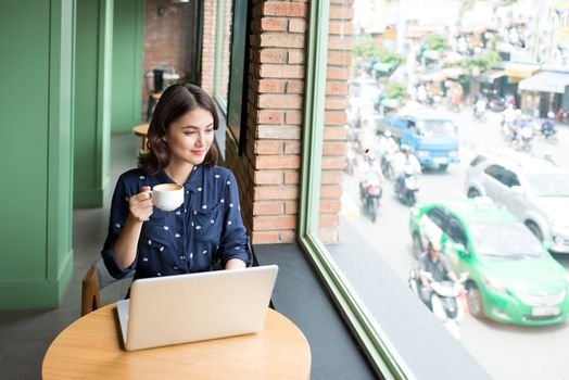 Beautiful cute asian young woman in the cafe, enjoy drinking coffee smiling