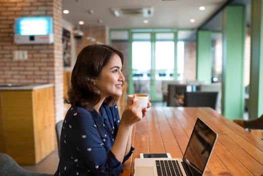 Portrait of Asian woman smiling in coffee shop cafe