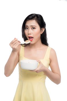 Asian woman eating bowl of cereal or muesli for breakfast