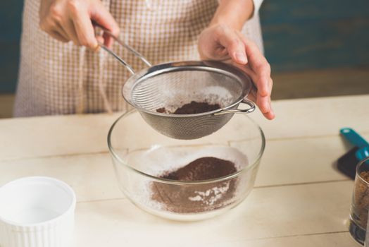 House wife wearing apron making. Steps of making cooking chocolate cake.