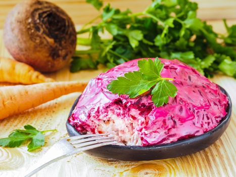 Close up view of homemade herring under a fur coat and ingredients. National festive Russian dish with beetroot. Served with fresh parsley