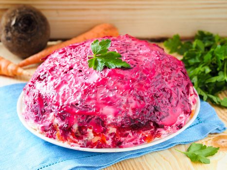 Close up view of homemade herring under a fur coat and ingredients. National festive Russian dish with beetroot. Served with fresh parsley