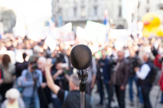 Microphone in focus, blurred crowd in background