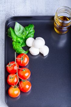 Caprese salad ingredients on a stone plate