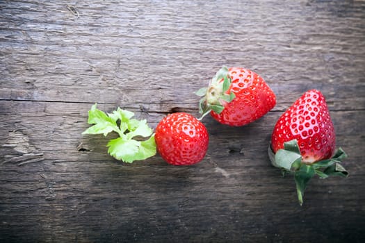 A fresh Strawberries on a wooden background.