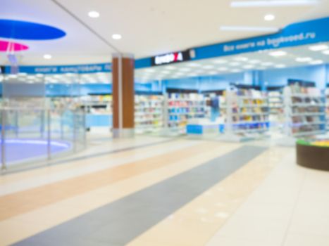 Shopping mall blur background with bokeh. Blurred hall of shopping mall as background.