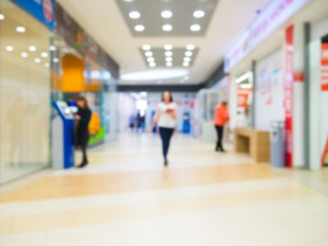 Shopping mall blur background with bokeh. Blurred hall of shopping mall as background.