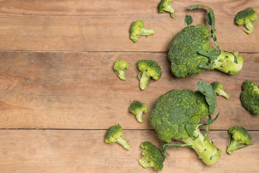 Top view of Fresh green broccoli on rustic wooden background - healthy or vegetarian food.
