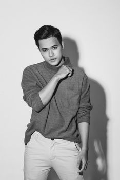 Young asian man's portrait against black background