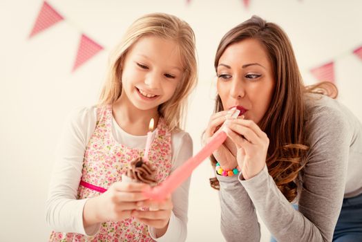 Cute daughter and her young mother having fun for Mother's Day. 