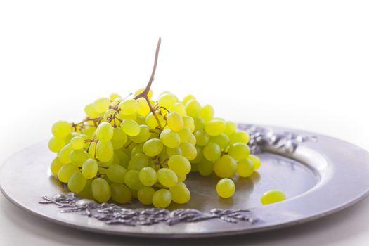 Bunch of white grapes on a tray.