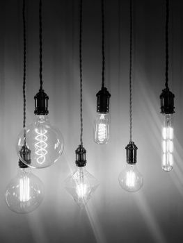 Industrial style light bulbs of different shapes. Black and white photo.