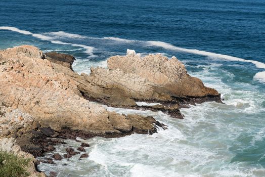 A rocky outcrop, resembling a dragon, in the sea next to Clarence Drive between Gordons Bay and Rooi-Els
